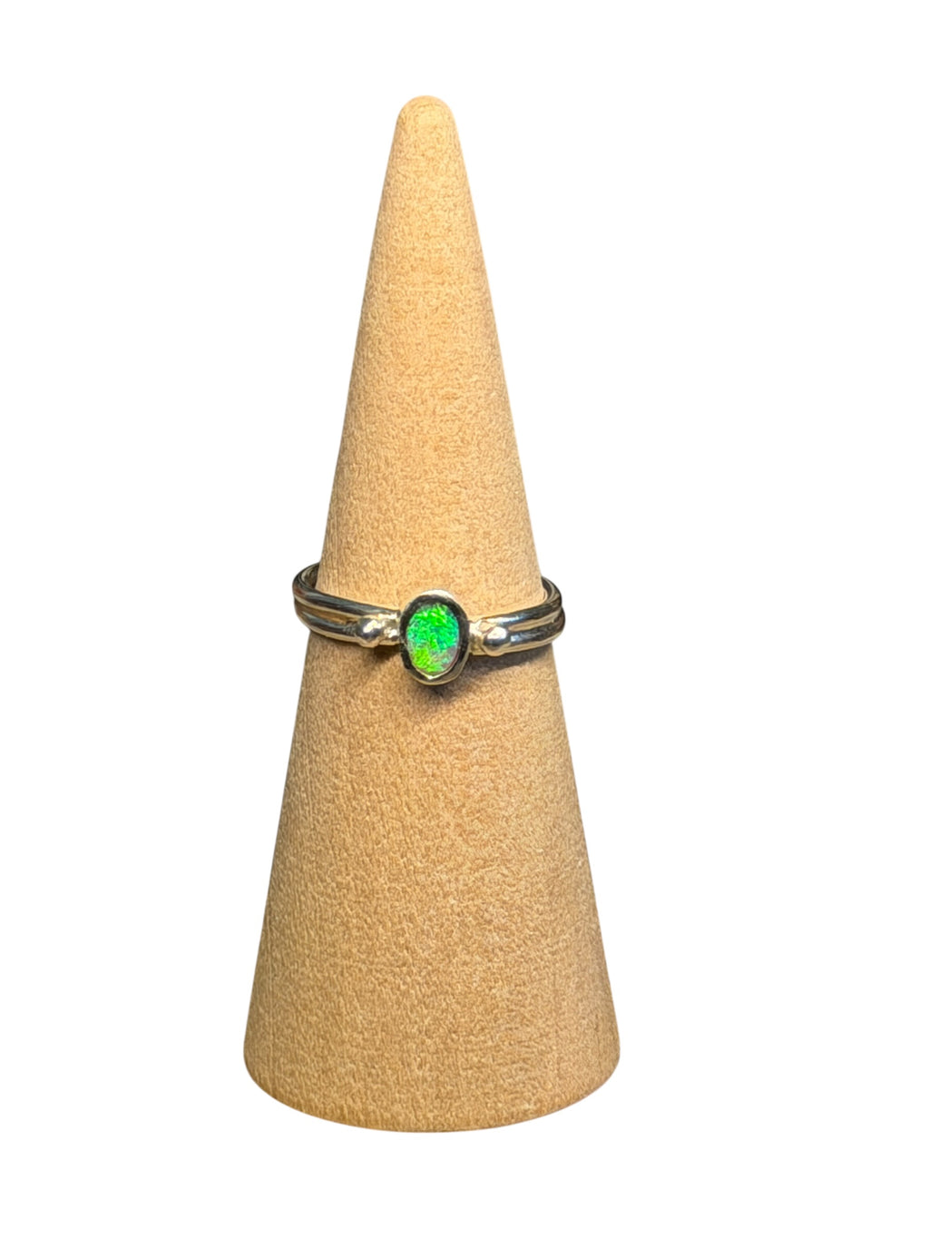 Ring with a green opal gemstone on a beige cone-shaped stand against a white background