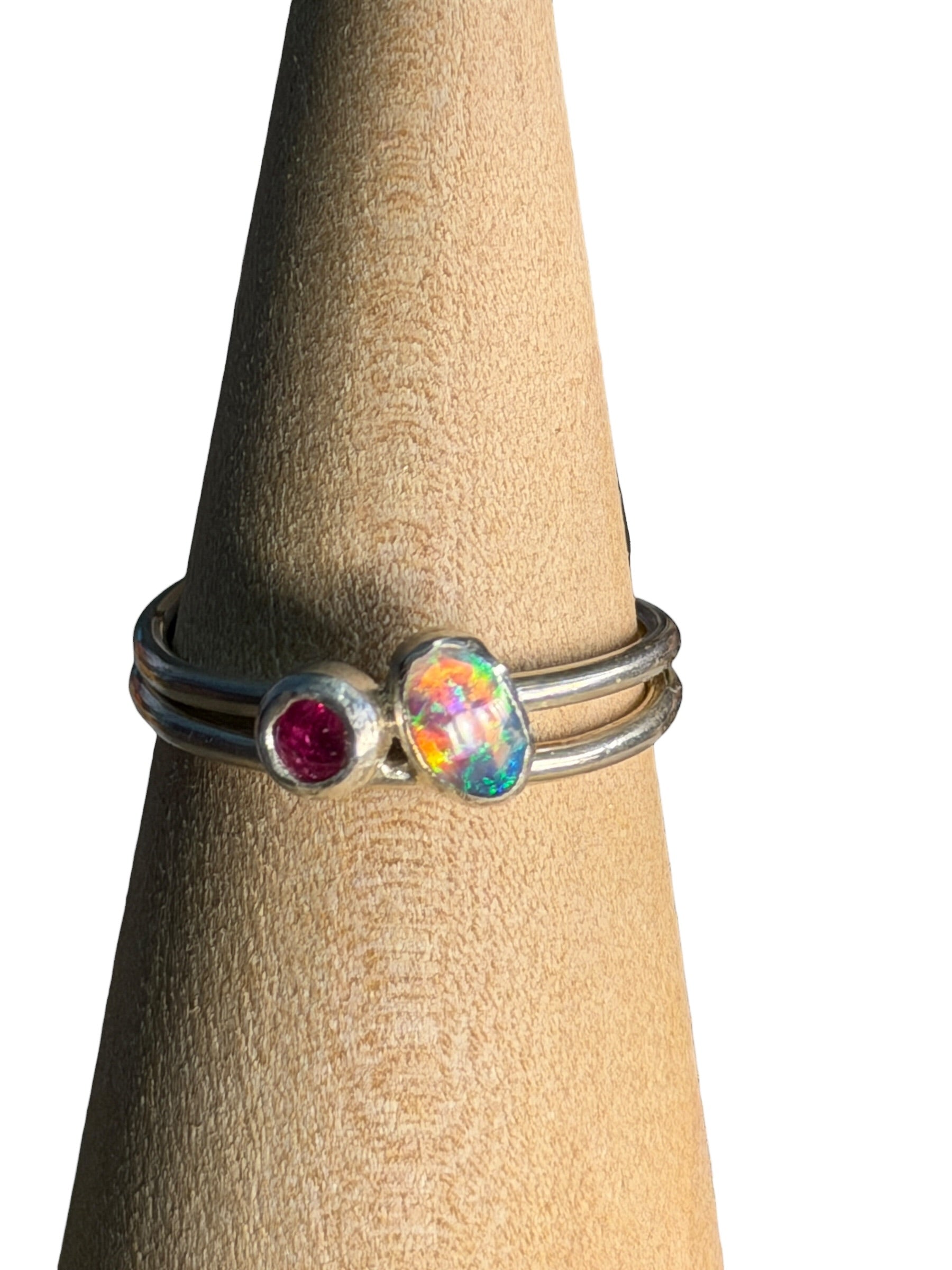 Silver ring with gemstones on a wooden block